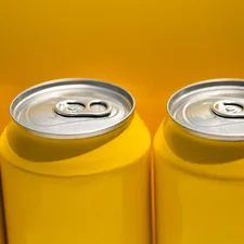 Yellow beer cans, with yellow backdrop. Outside in the California sunshine related to Add a Pop of Sunshine with Yellow Chevron Valance