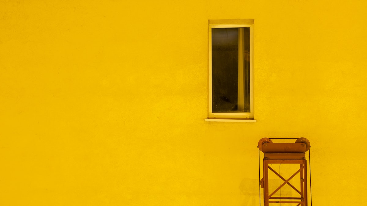 yellow painted house with window related to Elevate Your Windows with Yellow and Grey Valances