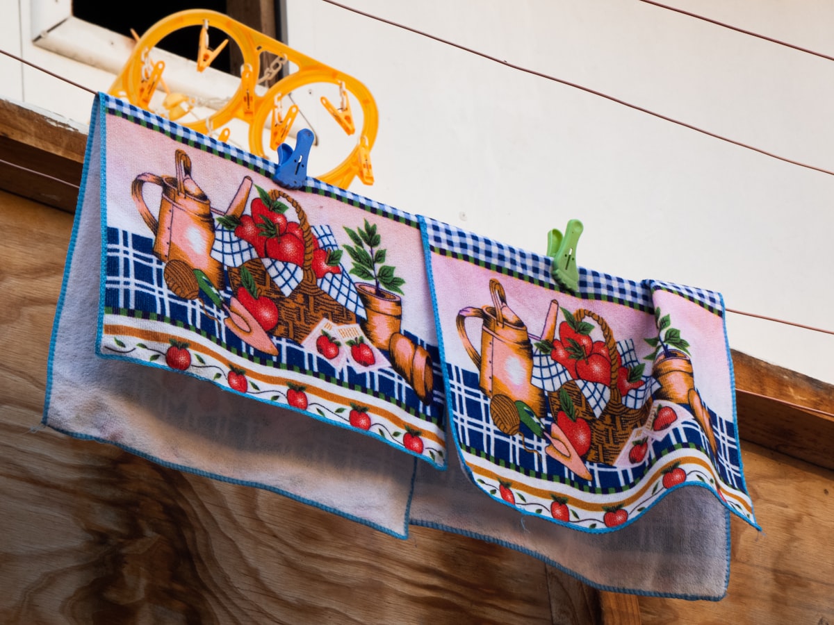 yellow plastic chair on white and blue floral textile related to Burlap Kitchen Valance: Embrace Organic Elegance