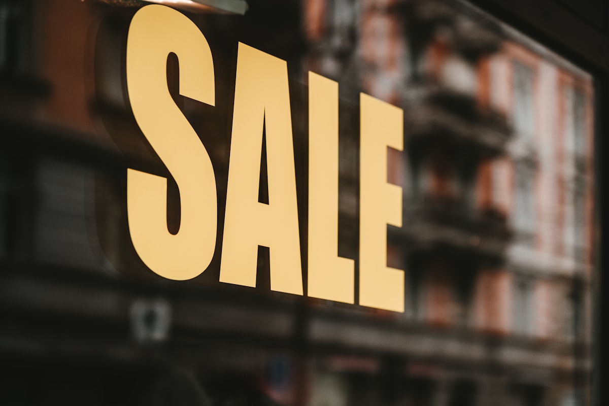 yellow sale text printed on glass window related to Window Valances on Sale