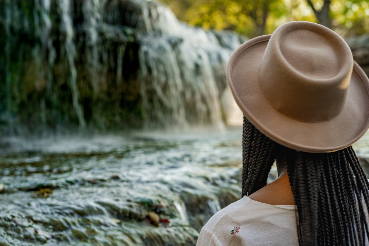 Young black woman gazing at a waterfall.  related to Beaded Waterfall Valance: Elevate Your Home Decor