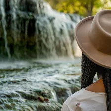 Young black woman gazing at a waterfall.  related to Beaded Waterfall Valance: Elevate Your Home Decor