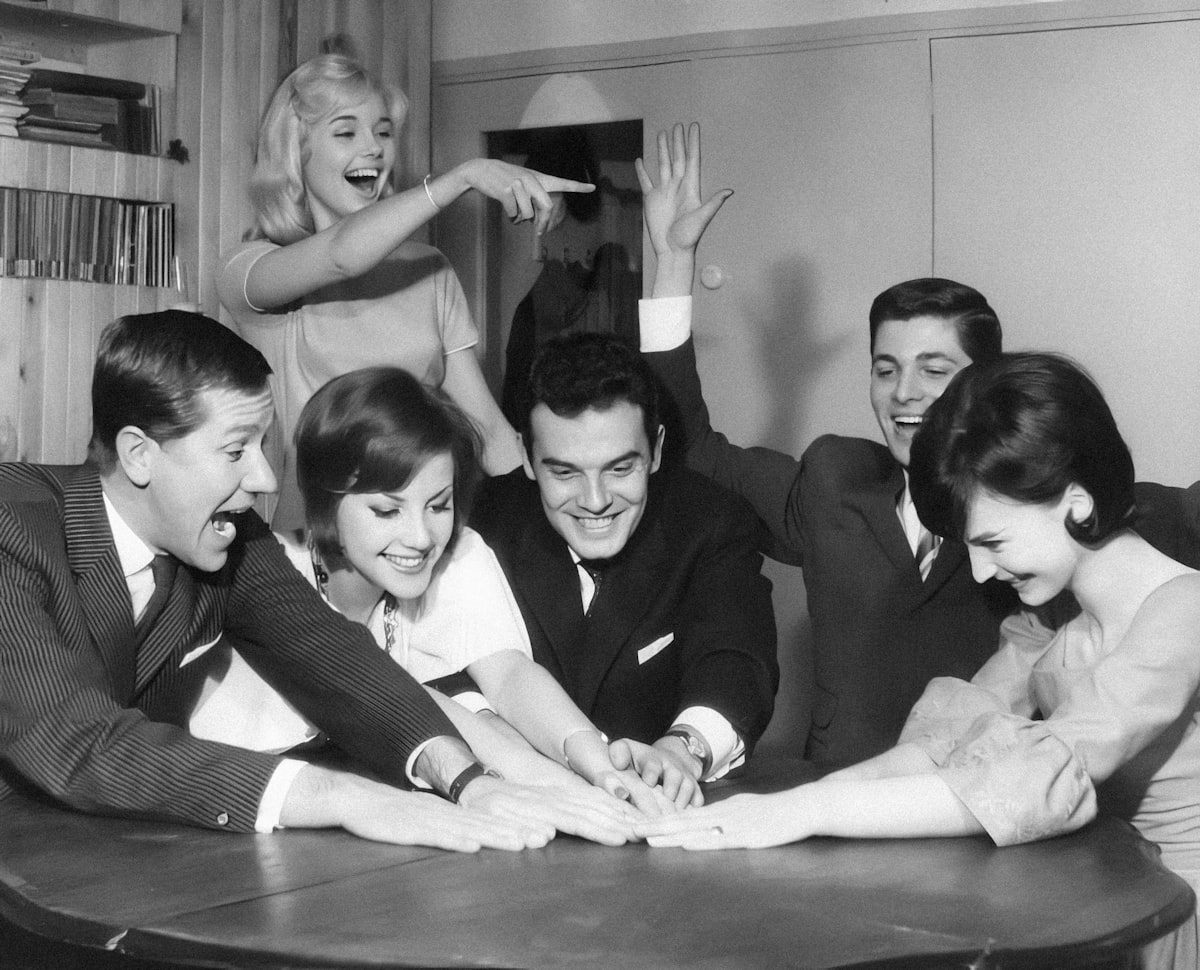 Youngsters having a good time. The Netherlands, 1961. Jongeren doen gezelschapsspel. Nederland, 1961. SFA004001952 Nationaal Archief/Spaarnestad Photo/Walter Blum related to Cozying Up: The Benefits and History of Cast Iron Chimineas