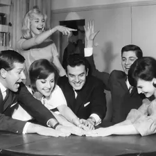 Youngsters having a good time. The Netherlands, 1961. Jongeren doen gezelschapsspel. Nederland, 1961. SFA004001952 Nationaal Archief/Spaarnestad Photo/Walter Blum related to Cozying Up: The Benefits and History of Cast Iron Chimineas
